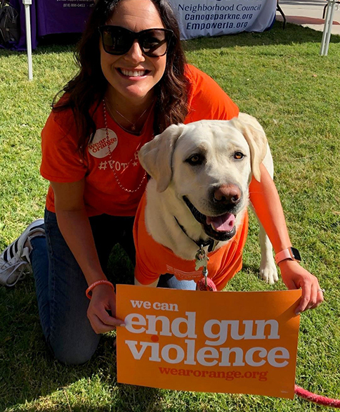Person and dog advocating against gun violence.